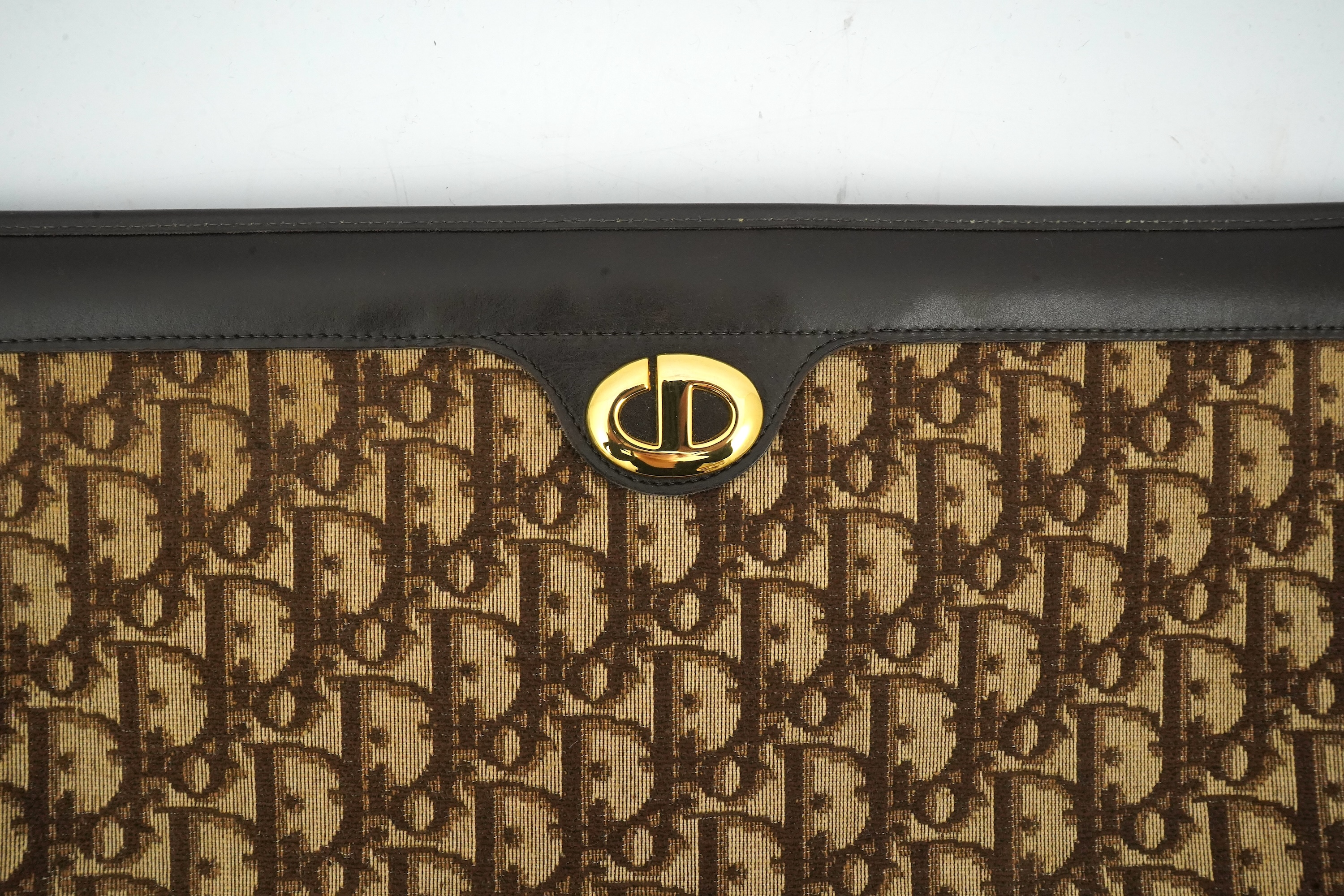 A vintage Dior brown cloth and leather trim monogram clutch bag